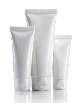 Blank plastic tubes of cosmetic products on white background. Mockup for design. High quality photo