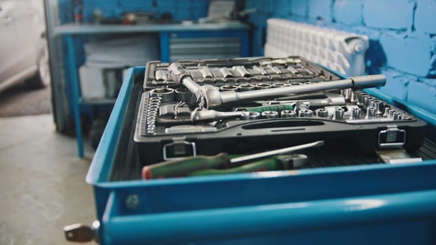 A set of tools for repair - screwdriver, voltmeter, wrenches - car service, close up view