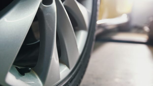 Luxury yellow sport car in garage auto service - diagnostics and repairing, close up