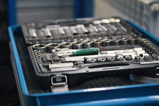 A set of tools for repair - screwdriver, voltmeter, wrenches - car service, close up view