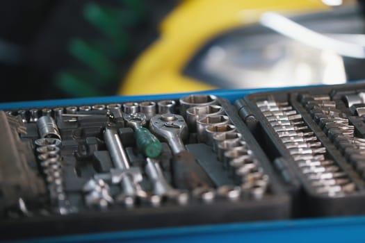 A set of tools for repair - screwdriver, voltmeter, wrenches - car service, close up view