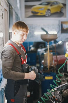 Mechanic works with voltmeter - car electrics - electrical wiring, close up