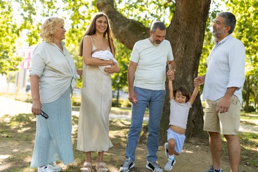 Multi-generation family is spending time together in a park