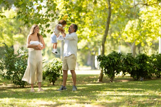 Happy family having fun spending time together in park