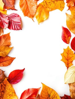 Colorful autumn leaves in shades of red, orange, and yellow frame a sheet of recycled paper laid on a weathered wooden table, creating a seasonal backdrop.