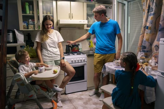 A loving family is happily enjoying quality time together in their cozy kitchen, showcasing warmth and connection