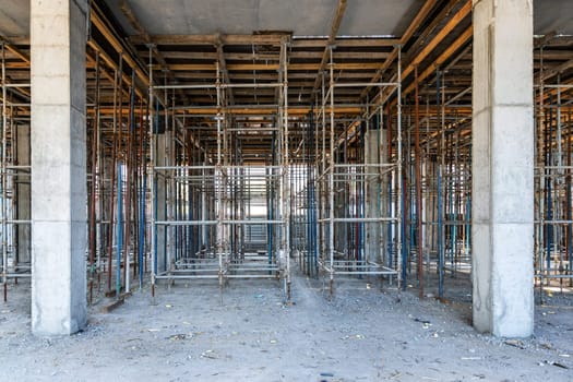Scaffolding Unveiled Beneath the Ceiling for Concrete Pouring at a Construction Site.