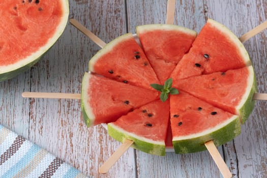 Fresh watermelon slices on sticks.