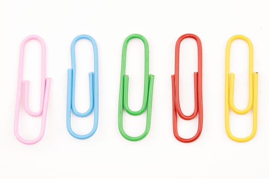 A concept photo of multi-colored paper clips on a white background.