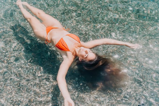 Weight loss and body image concept. Woman with perfect fit body walking confident on beach. Unrecognizable sexy young woman.