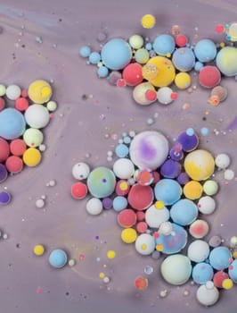 An array of colorful bubbles in various sizes float against a soft pastel backdrop, showcasing a blend of hues and textures that evoke creativity and joy.