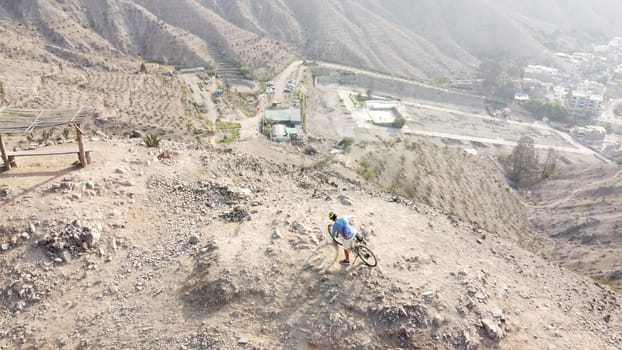 Man riding mountain bikes along the barren rocky terrain