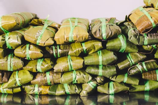 Tamales, a Peruvian dish made with corn dough, chicken or pork and chili, wrapped with a corn or banana leaf