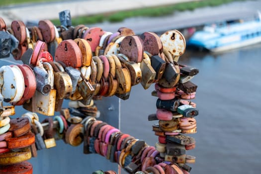 Love locks with names and dates. Tradition of hanging a lock during a wedding. Selective focus.