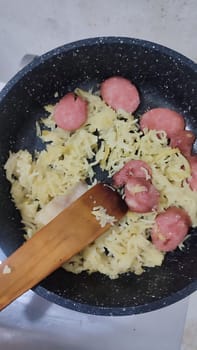 pasta with sausage in a frying pan, dinner lunch food cooking. High quality photo