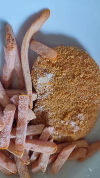 sweet potato yam chips, schnitzel and bun in a plate, food lunch cooking. High quality photo