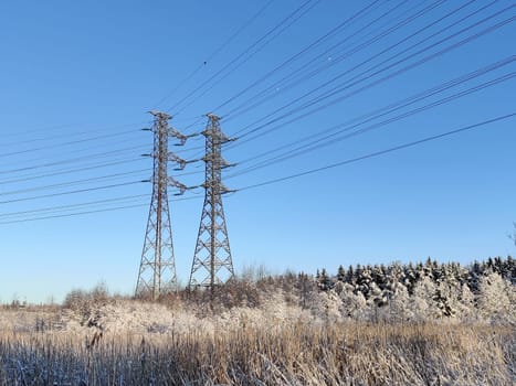 High voltage electricity tower landscape at sunset. Transmission. High voltage tower with electricity transmission power lines. Electricity. High power electricity pylon. Smart grid. Transmission lines over sky. Transmission towers. Finland, Europe