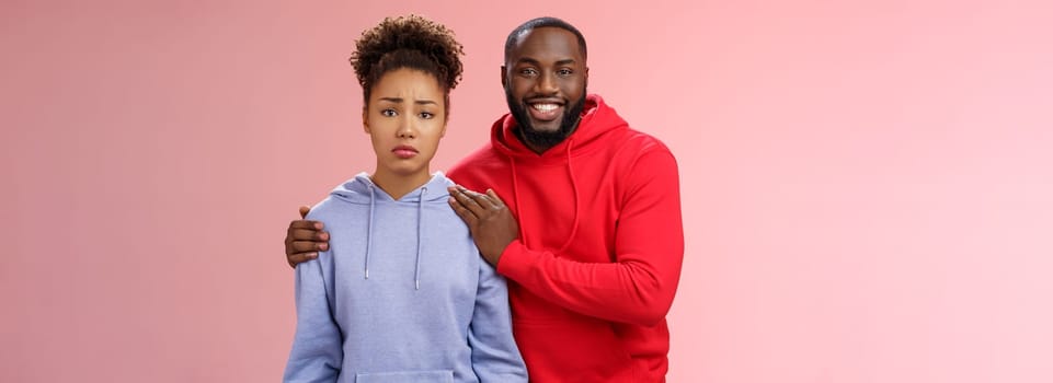 Girl unwilling participate event feel nervous insecure boyfriend encouraging hugging boost confidense assuring everything alright smiling self-assured promise everything be okay, pink background.