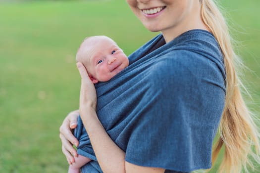 Mom walks with her newborn baby in a sling. This moment highlights the close bond between mother and child, promoting comfort, security, and the benefits of babywearing in everyday life.