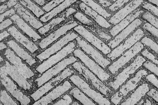 The road surface is made of bricks.