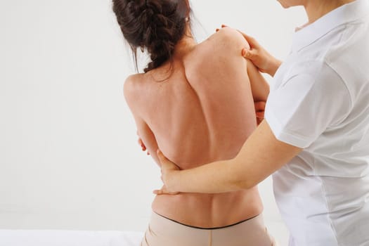 a therapist rehabilitation specialist checks the mobility of the spinal arches. Evaluation of the preservation of mobility in the lumbar and thoracic region