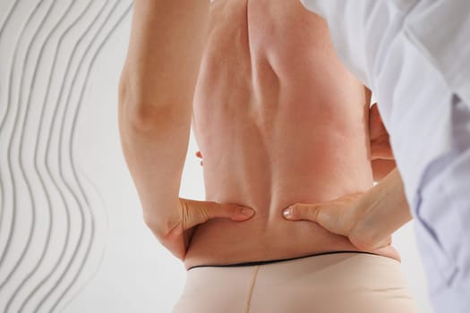 a therapist rehabilitation specialist checks the mobility of the spinal arches. Evaluation of the preservation of mobility in the lumbar and thoracic region