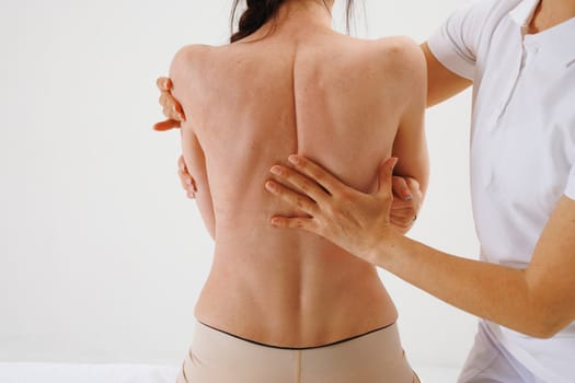 a therapist rehabilitation specialist checks the mobility of the spinal arches. Evaluation of the preservation of mobility in the lumbar and thoracic region