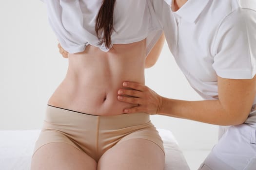 a therapist rehabilitation specialist checks the mobility of the spinal arches. Evaluation of the preservation of mobility in the lumbar and thoracic region