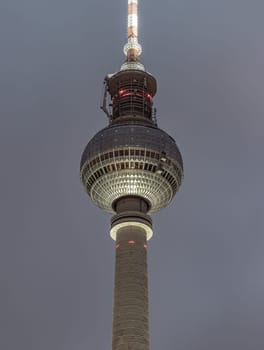 Berlin, Germany - Dec 18, 2023 - Famous Berlin Television Tower (Fernsehturm) with night sky background near Alexanderplatz in Berlin, A Tourist attraction and Meeting place, Space for text, Selective focus.