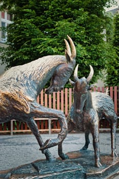 A close-up image of the famous goat statues in Poznan, Poland, representing a well-known local legend. The bronze sculptures depict two goats facing each other in a dynamic pose, symbolizing the city cultural heritage. These statues are located in the city center and are a significant part of Poznan historical and artistic landscape. Perfect for use in travel, cultural, and historical themes.