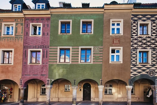 A vibrant image of beautifully painted historic townhouses located in the heart of Warsaw Old Town. These colorful facades showcase the architectural charm and cultural heritage of Poland capital. The intricate patterns and pastel hues of the buildings evoke the spirit of traditional European city squares. This image is ideal for use in travel, architecture, and cultural heritage themes.