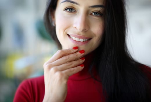 Woman's smile and fingers with red nails. Classic female manicure concept