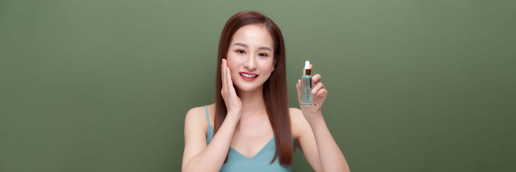 beautiful female using anti-aging treatment product on green,panorama