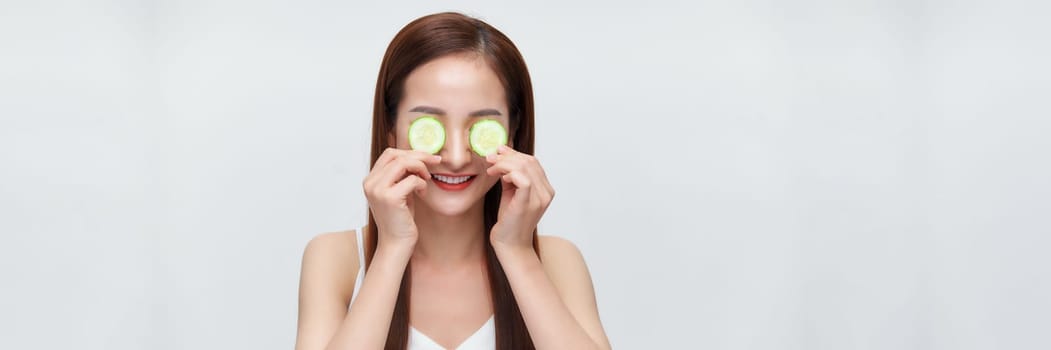 Banner of woman with cucumber slices on her eyes 