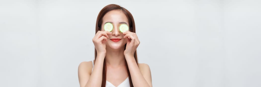 Banner of woman with cucumber slices on her eyes 