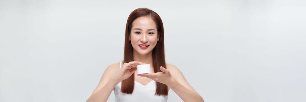 happy young woman holding jar of cream over white banner