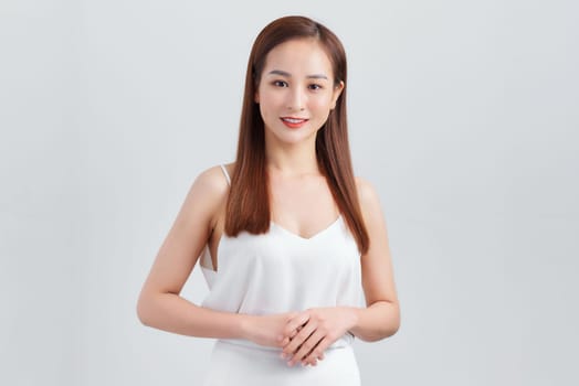 Young Asian woman posing on white background
