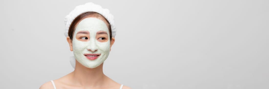 Skin care. Young woman with cosmetic clay mask on white banner
