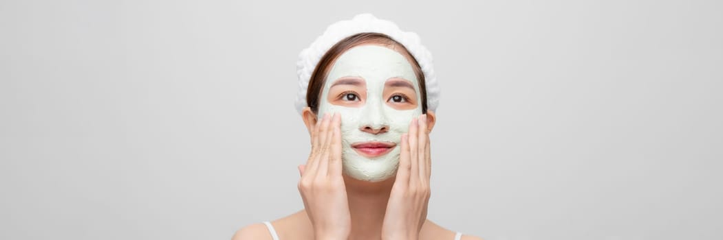 Spa girl applying facial mask. Beauty treatments.