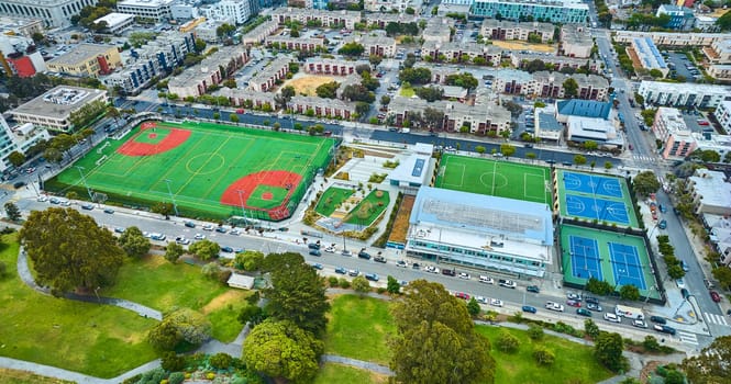 Image of Aerial apartment buildings with multiple sport fields and courts in San Francisco