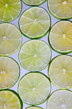 Image of Bright and seedless green lime slices on white background