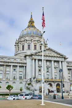 Image of Betsy Ross flag in front of city hall with steam coming out of vent near entrance