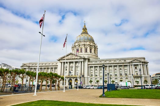 Image of Betsy Ross and other American flags in front of San Francisco city hall building