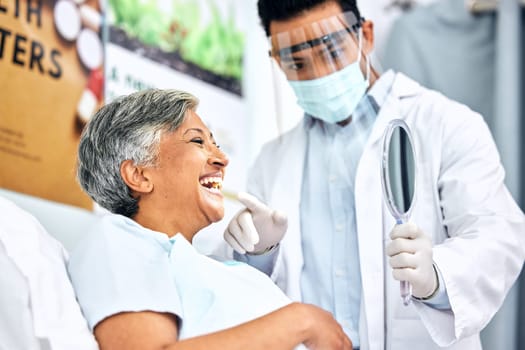 Dental, healthcare or mirror with a dentist and patient consulting in an oral hygiene appointment. Teeth, cleaning and mature woman client at the orthodontist for a medical checkup to prevent decay.