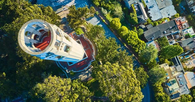 Image of Aerial over Coit Tower with downward view of roof with red floor and stairs