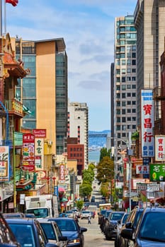 Image of Street packed with cars in San Francisco Chinatown with view of bay waters