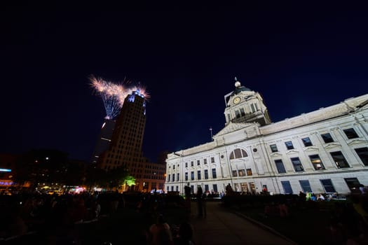Image of Fireworks at night behind Lincoln Tower with people crowding courthouse lawn downtown Fort Wayne