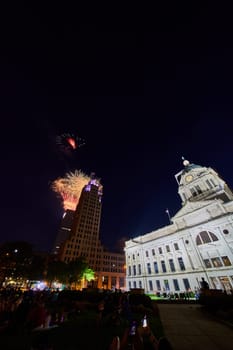 Image of Fireworks in downtown Fort Wayne with courthouse and crowd of people watching