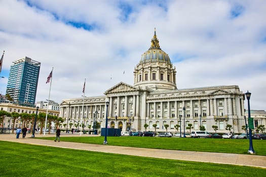 Image of City hall in San Francisco with pedestrians on sidewalk and cloudy blue sky overhead