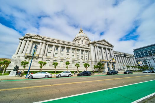 Image of Wide view of San Francisco city hall with cars parked along street